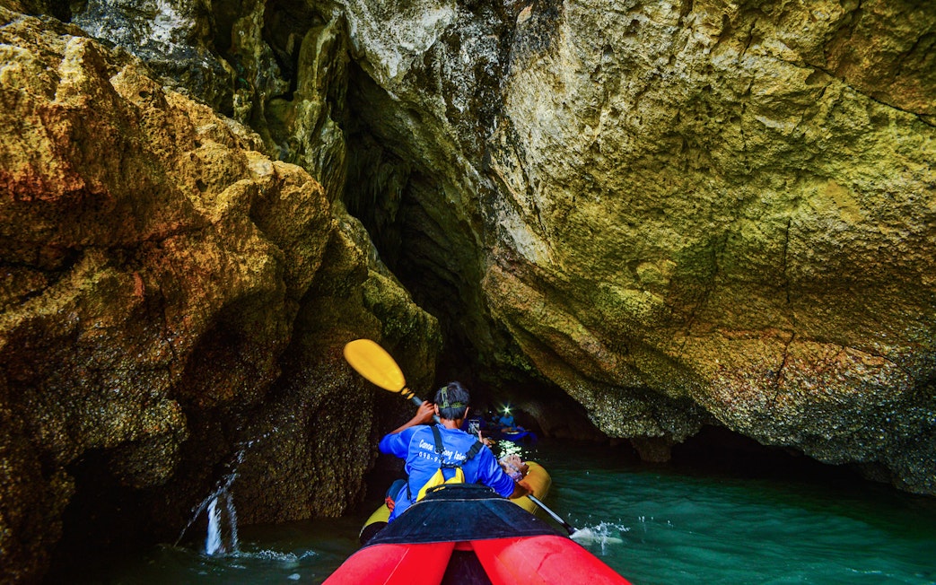 Kayaking through cave at Phang Nga Bay, Thailand.
