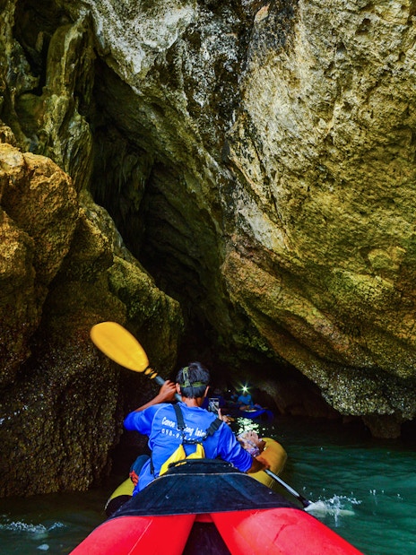 Kayaking through cave at Phang Nga Bay, Thailand.