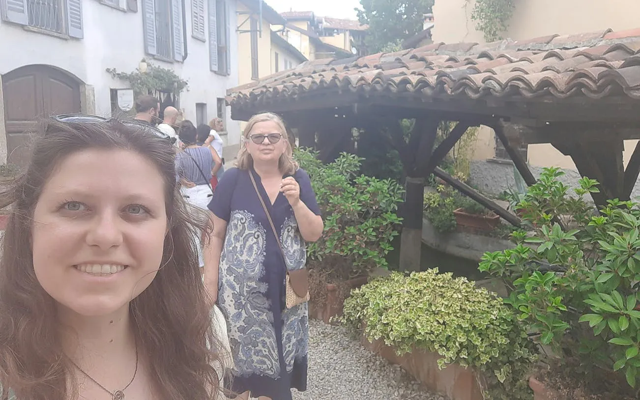 Visitors exploring a quaint street in Milan's Navigli district during a self-guided city game.