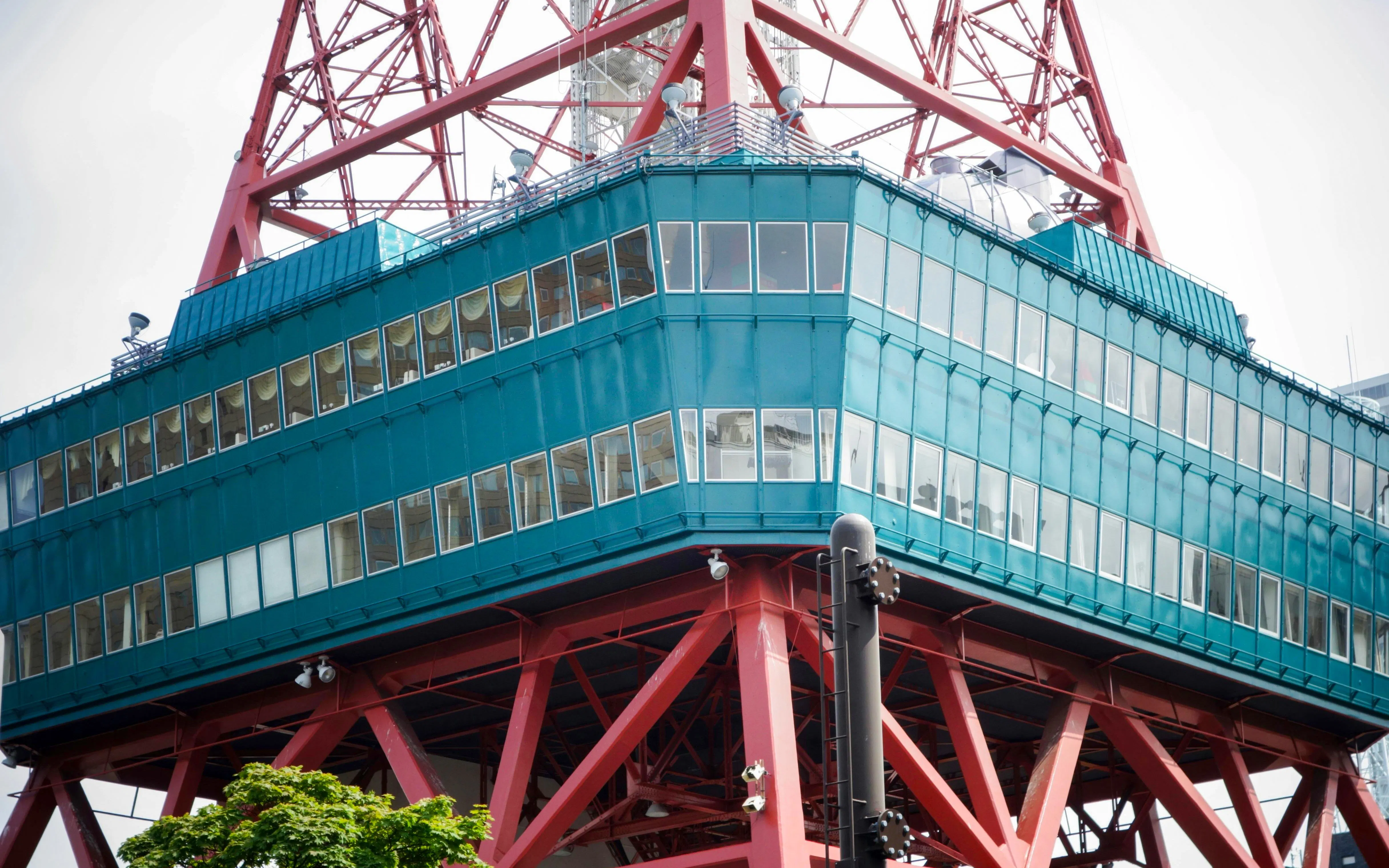 Sapporo TV Tower green observation deck and red structure close-up.