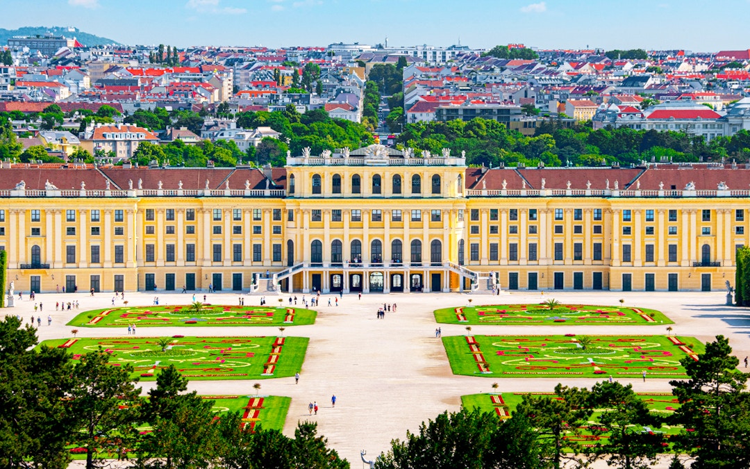 Aerial view of Schönbrunn Palace gardens and facade in Vienna, Austria.