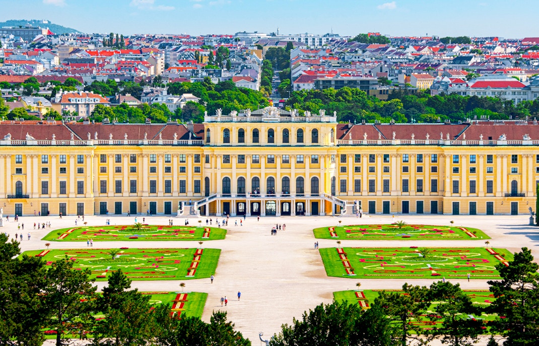 Aerial view of Schönbrunn Palace gardens and facade in Vienna, Austria.