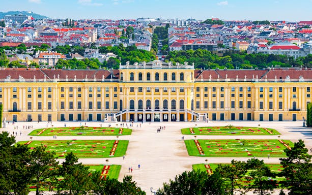 Aerial view of Schönbrunn Palace gardens and facade in Vienna, Austria.