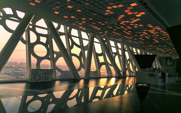 Dubai Frame interior with geometric patterns and city view at sunset.