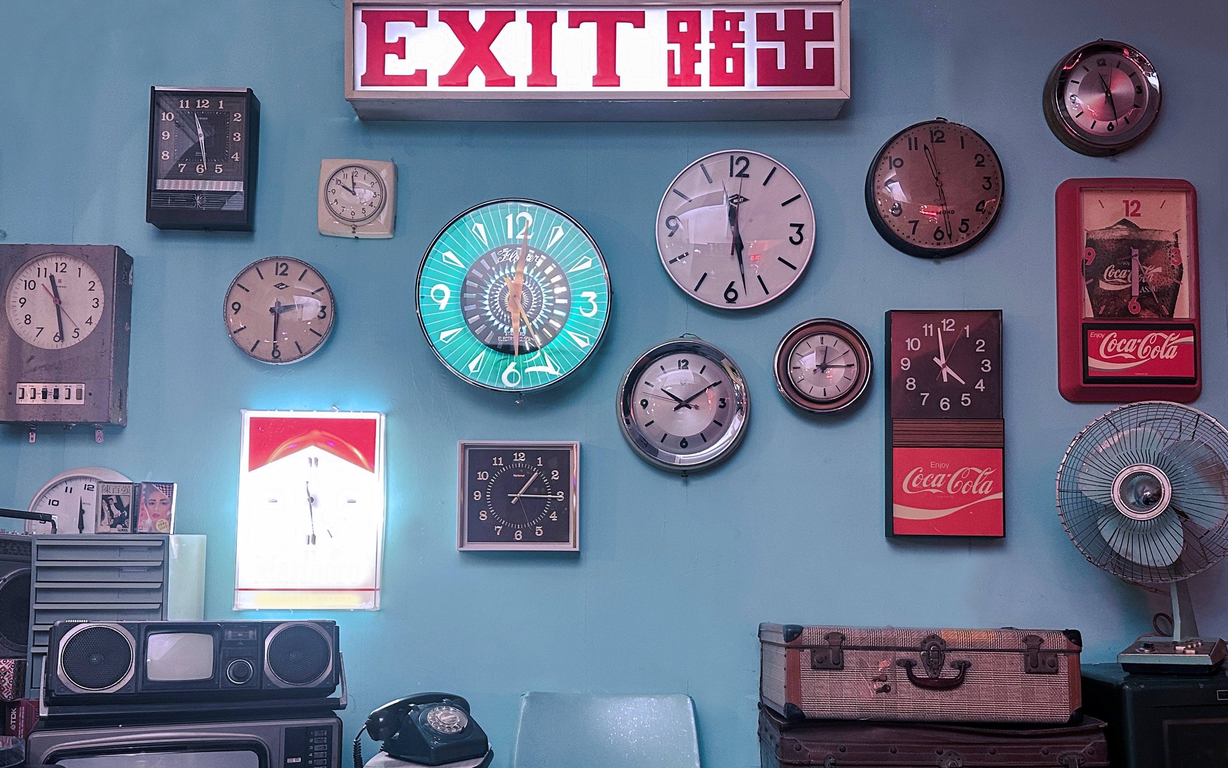 Exit sign and vintage clocks display at Hong Kong Peak Tram & Sky Terrace.