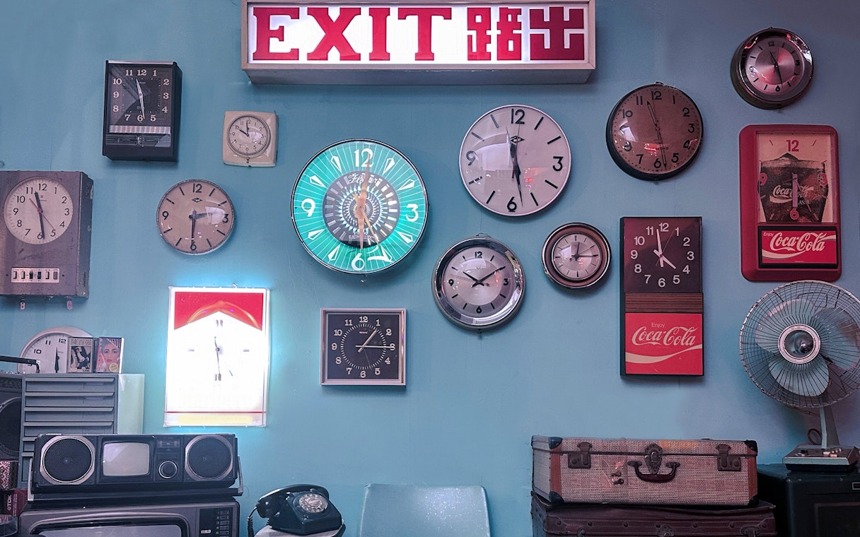 Exit sign and vintage clocks display at Hong Kong Peak Tram & Sky Terrace.