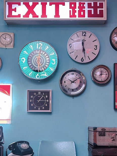 Exit sign and vintage clocks display at Hong Kong Peak Tram & Sky Terrace.