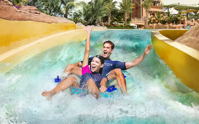 Tourists enjoying water slide at Aquaventure Waterpark, Dubai.