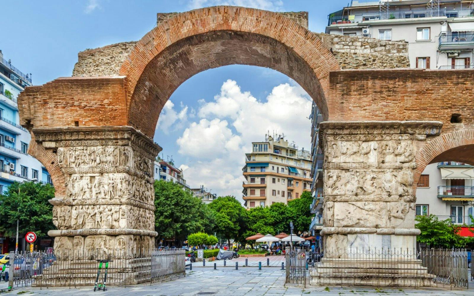 Arch of Galerius in Thessaloniki, Greece with detailed carvings and cityscape background.