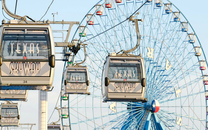 Texas Skyway gondolas with Ferris wheel at State Fair of Texas.