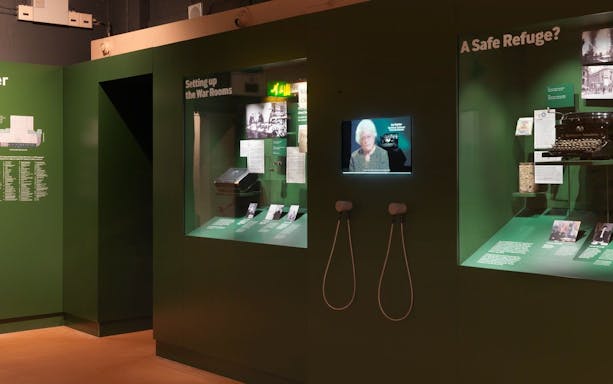 Churchill War Rooms Museum exhibit with historical displays and interactive screens.