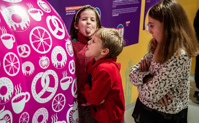 Children interacting with colorful exhibit at The City of Children and Youth.