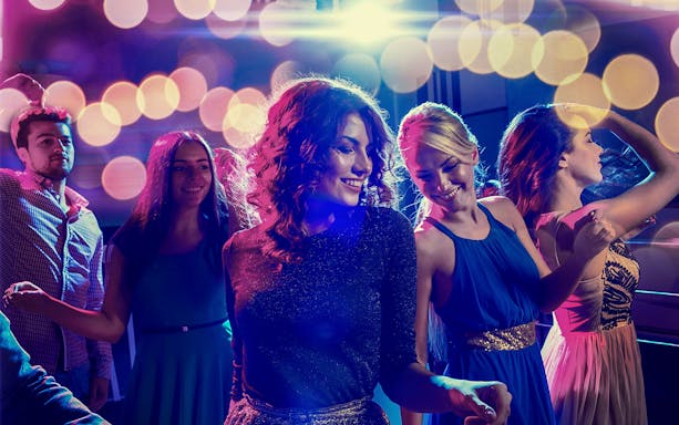 People dancing at PICCADILLY UMEDA Osaka nightclub with colorful lights.