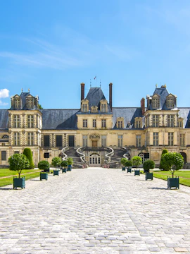 Château de Fontainebleau entrance with cobblestone path, near Paris, France.