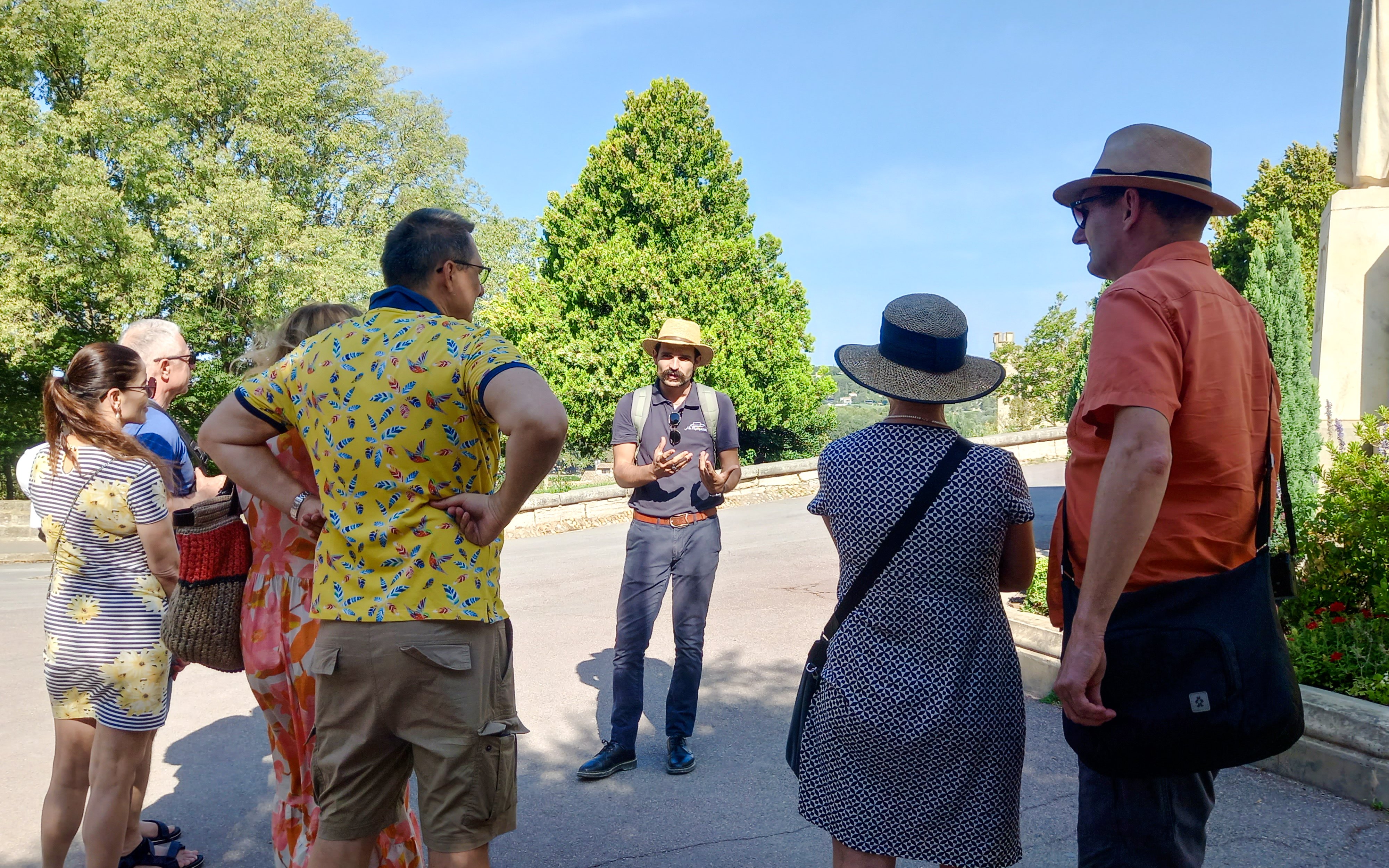 Tour guide leading a group at Rocher des Doms, Avignon.