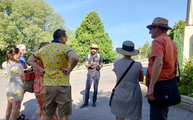 Tour guide leading a group at Rocher des Doms, Avignon.
