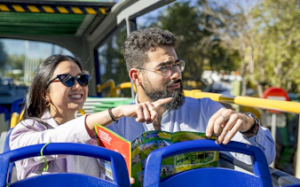 Couple enjoying Seville sights on Sevirama hop-on hop-off bus tour.