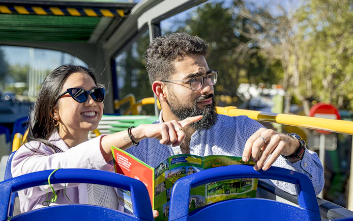 Couple enjoying Seville sights on Sevirama hop-on hop-off bus tour.