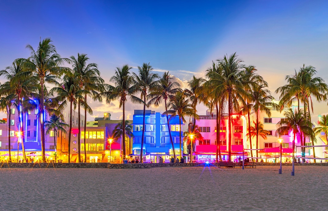 South Beach Ocean Drive, illuminated Art Deco buildings at night with palm trees.