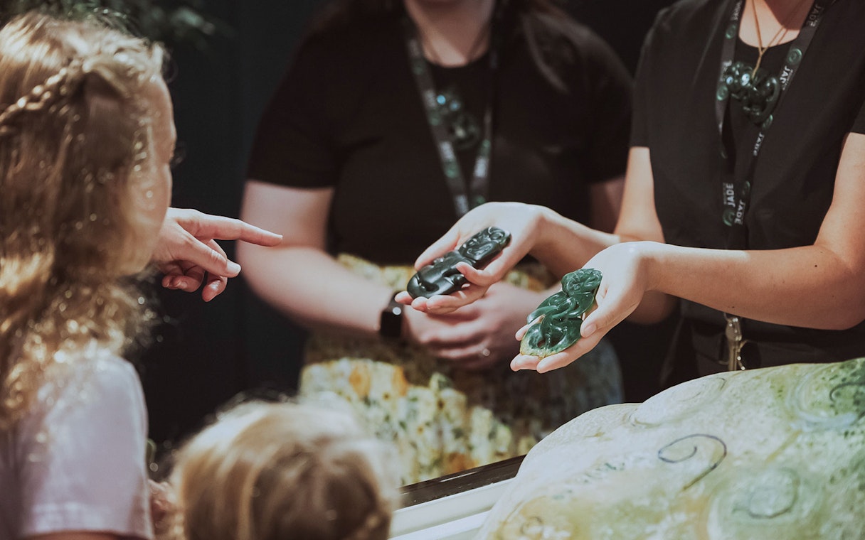 Hands holding jade carvings during Mountain Jade Highlights Tour.