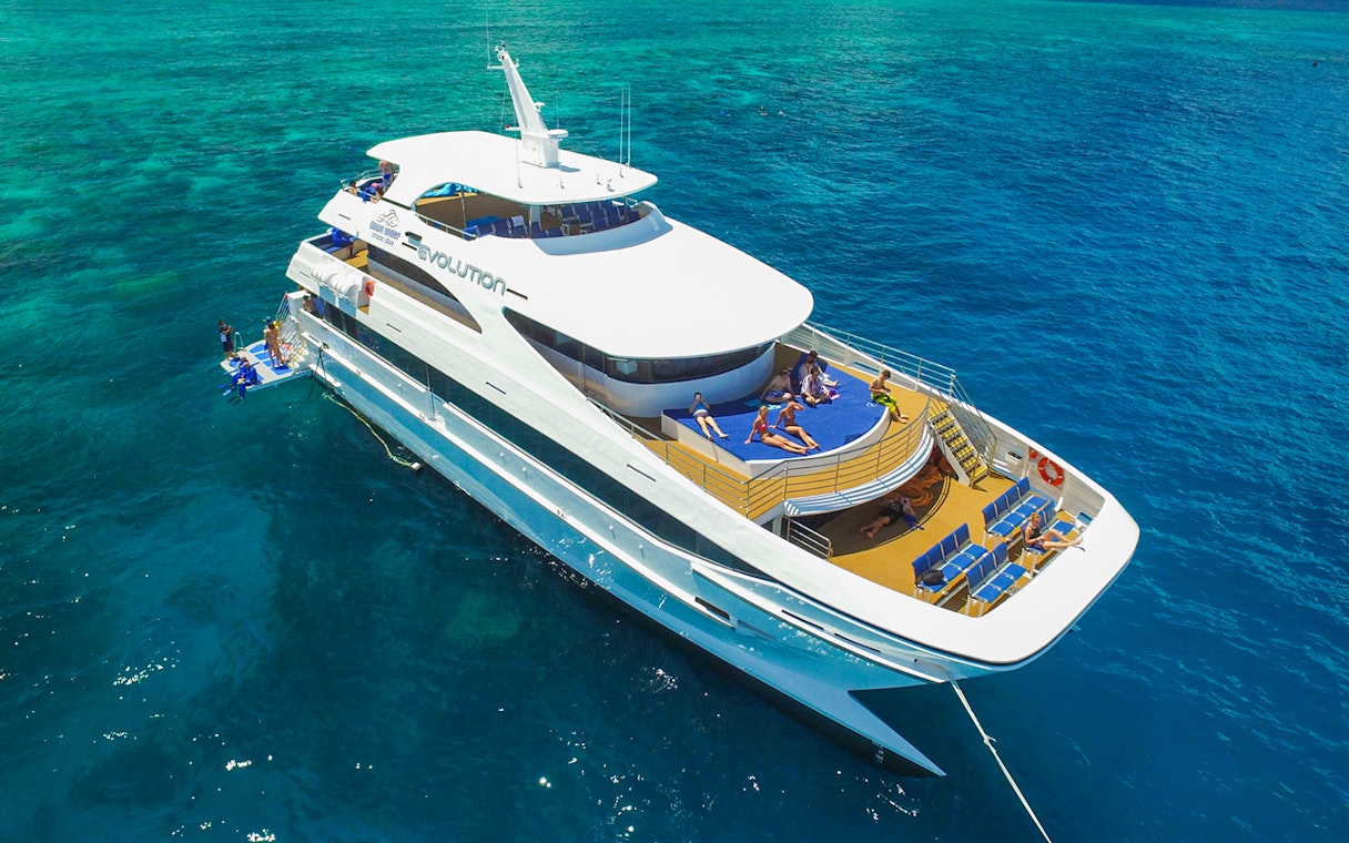 Tourists relaxing on a cruise ship deck in the Great Barrier Reef, Australia.