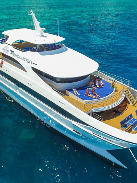 Tourists relaxing on a cruise ship deck in the Great Barrier Reef, Australia.