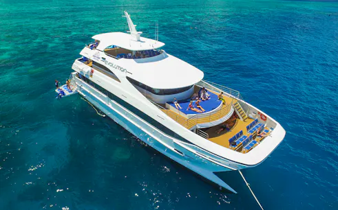 Tourists relaxing on a cruise ship deck in the Great Barrier Reef, Australia.