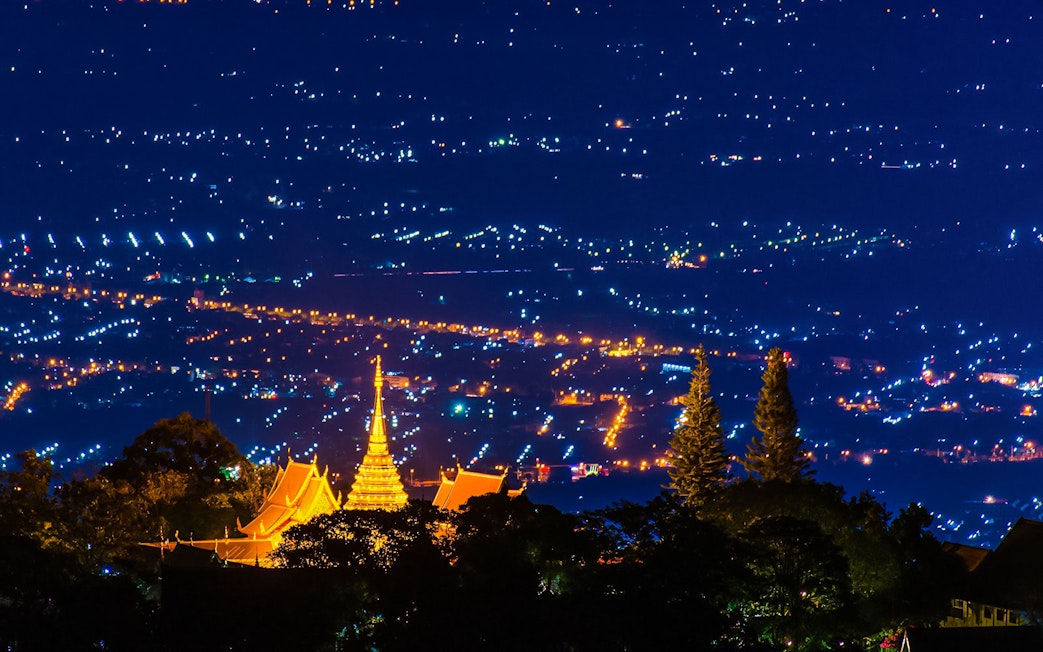 Wat Phra That Doi Suthep temple illuminated at night, overlooking Chiang Mai, Thailand.