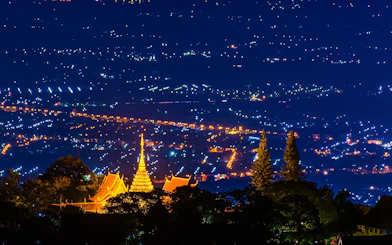 Wat Phra That Doi Suthep temple illuminated at night, overlooking Chiang Mai, Thailand.