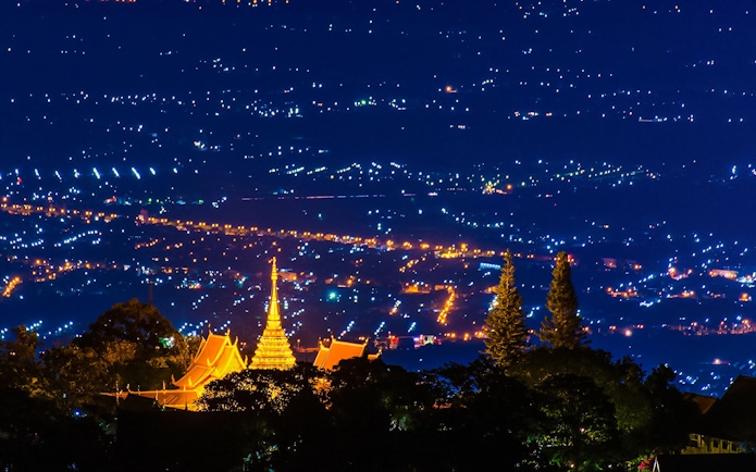 Wat Phra That Doi Suthep temple illuminated at night, overlooking Chiang Mai, Thailand.