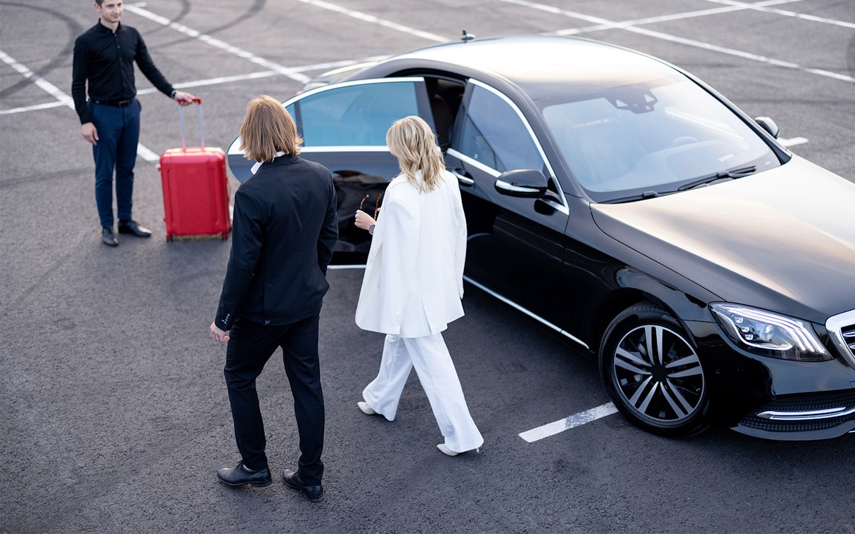 Private car transfer at Paris-Orly Airport with passengers and luggage.