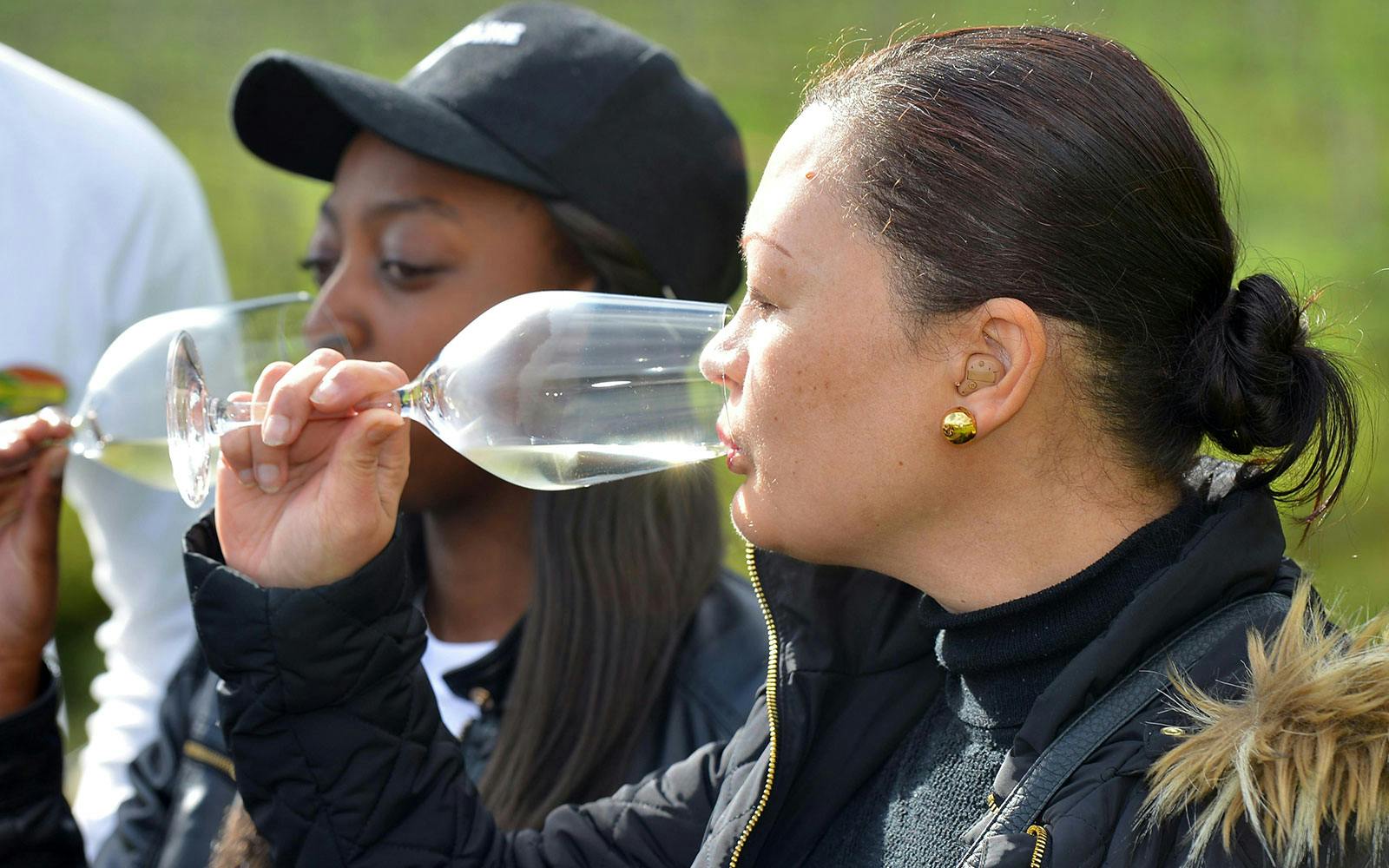 Tourists tasting wine at a vineyard in Constantia, South Africa.