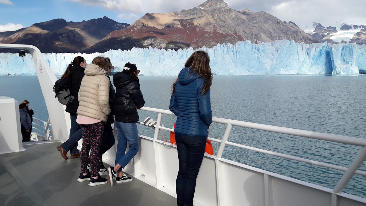 Tourists on cruise deck viewing Perito Moreno Glacier in Argentina.