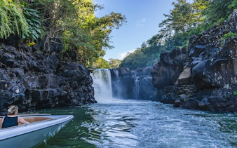 Boat approaching Grand River South East waterfall, Mauritius.