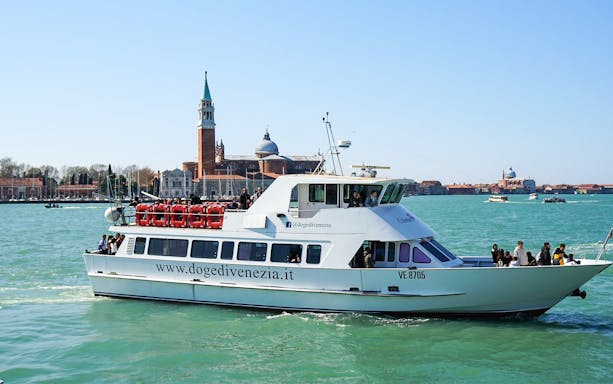 Boat cruising in Venice with San Giorgio Maggiore in the background.