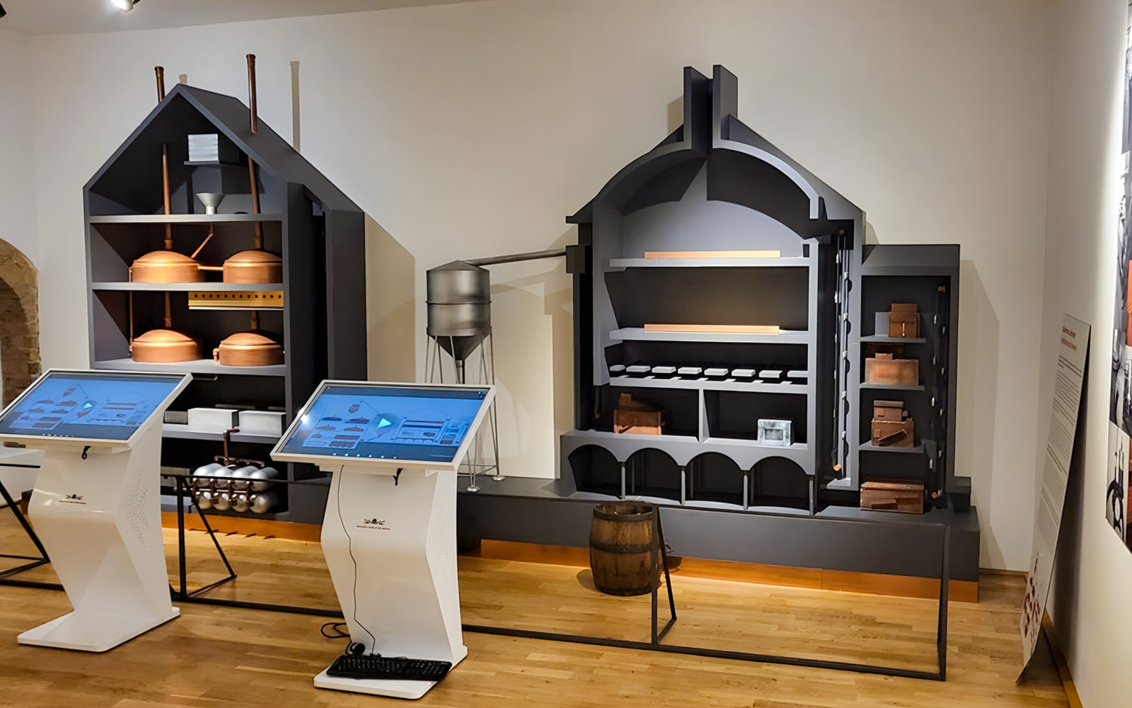 Interactive displays and brewing equipment inside Prague Beer Museum.