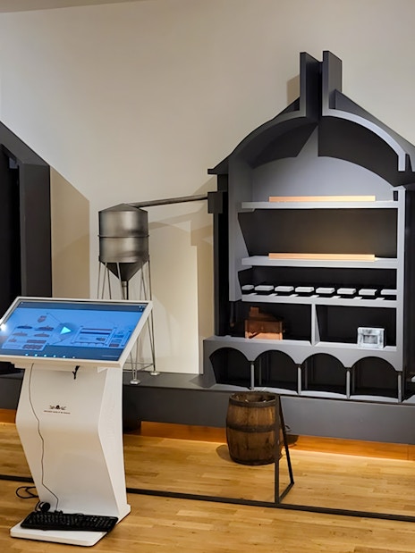 Interactive displays and brewing equipment inside Prague Beer Museum.