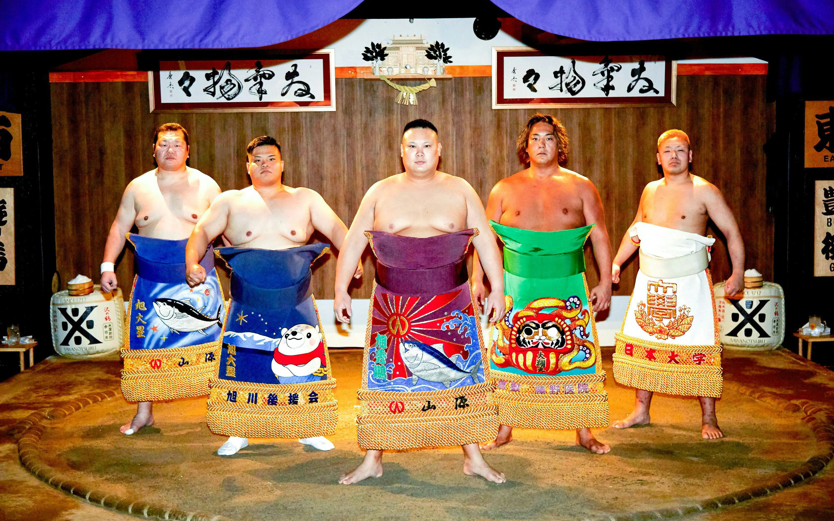 Sumo wrestlers in traditional attire at a ring session in Ginza, Central Tokyo.