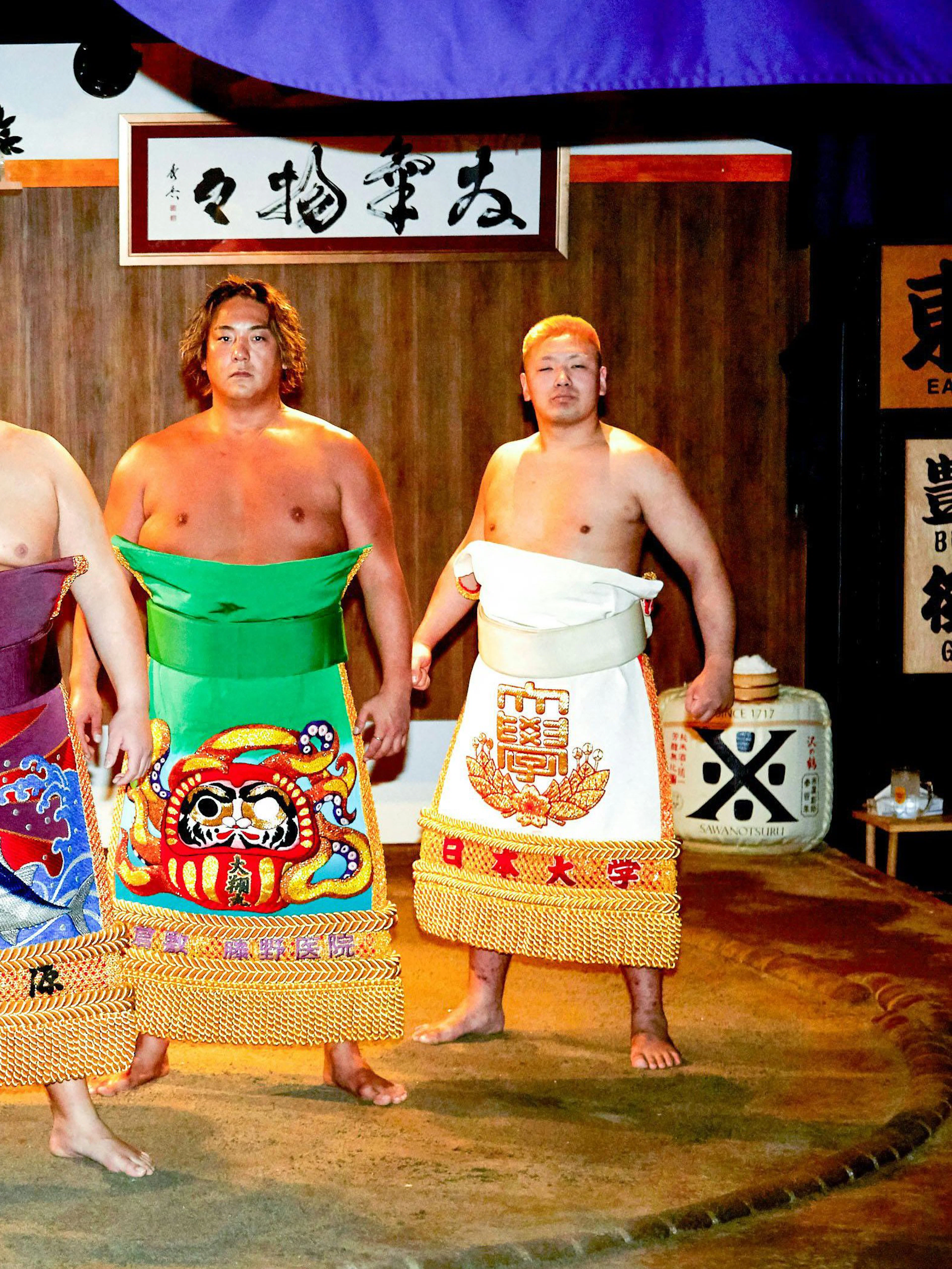 Sumo wrestlers in traditional attire at a ring session in Ginza, Central Tokyo.