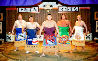 Sumo wrestlers in traditional attire at a ring session in Ginza, Central Tokyo.