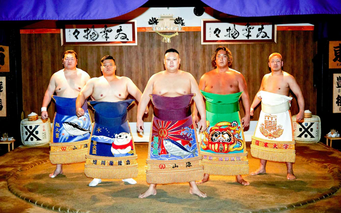 Sumo wrestlers in traditional attire at a ring session in Ginza, Central Tokyo.