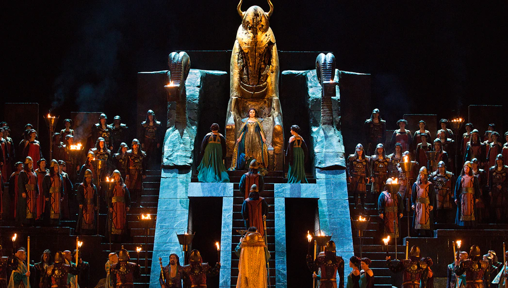 Opera performance of Nabucco with cast in ancient costumes on stage.