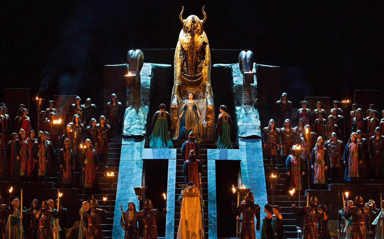 Opera performance of Nabucco with cast in ancient costumes on stage.