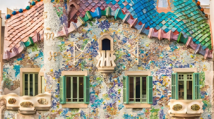 Casa Batllo facade with colorful mosaics and unique architecture in Barcelona.
