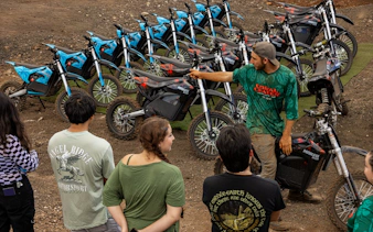 Instructor guiding group on electric dirt bikes in Oahu.