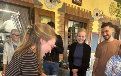 Cooking class participants making pasta at an Amalfi Coast farmhouse.
