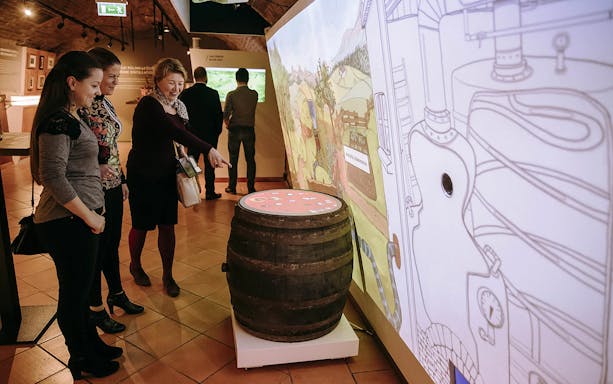 Visitors exploring interactive exhibit at Budapest Pálinka Museum.