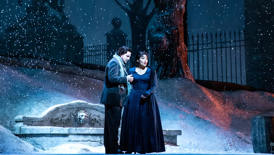 Opera performers in a snowy scene from La Boheme.