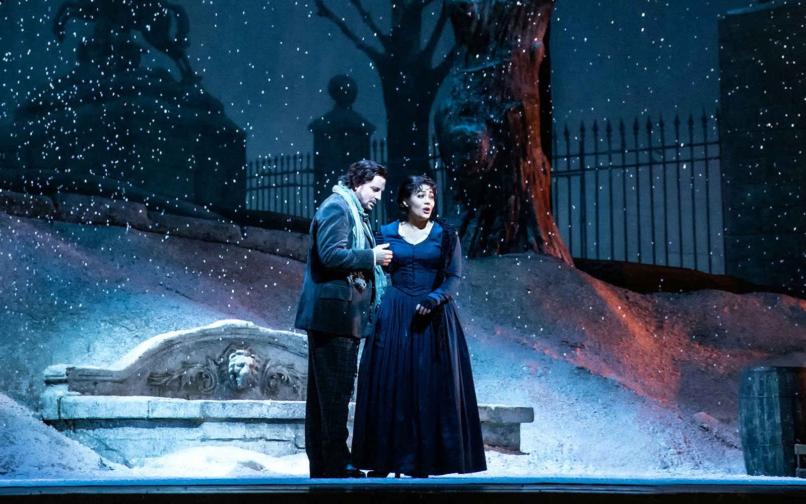 Opera performers in a snowy scene from La Boheme.