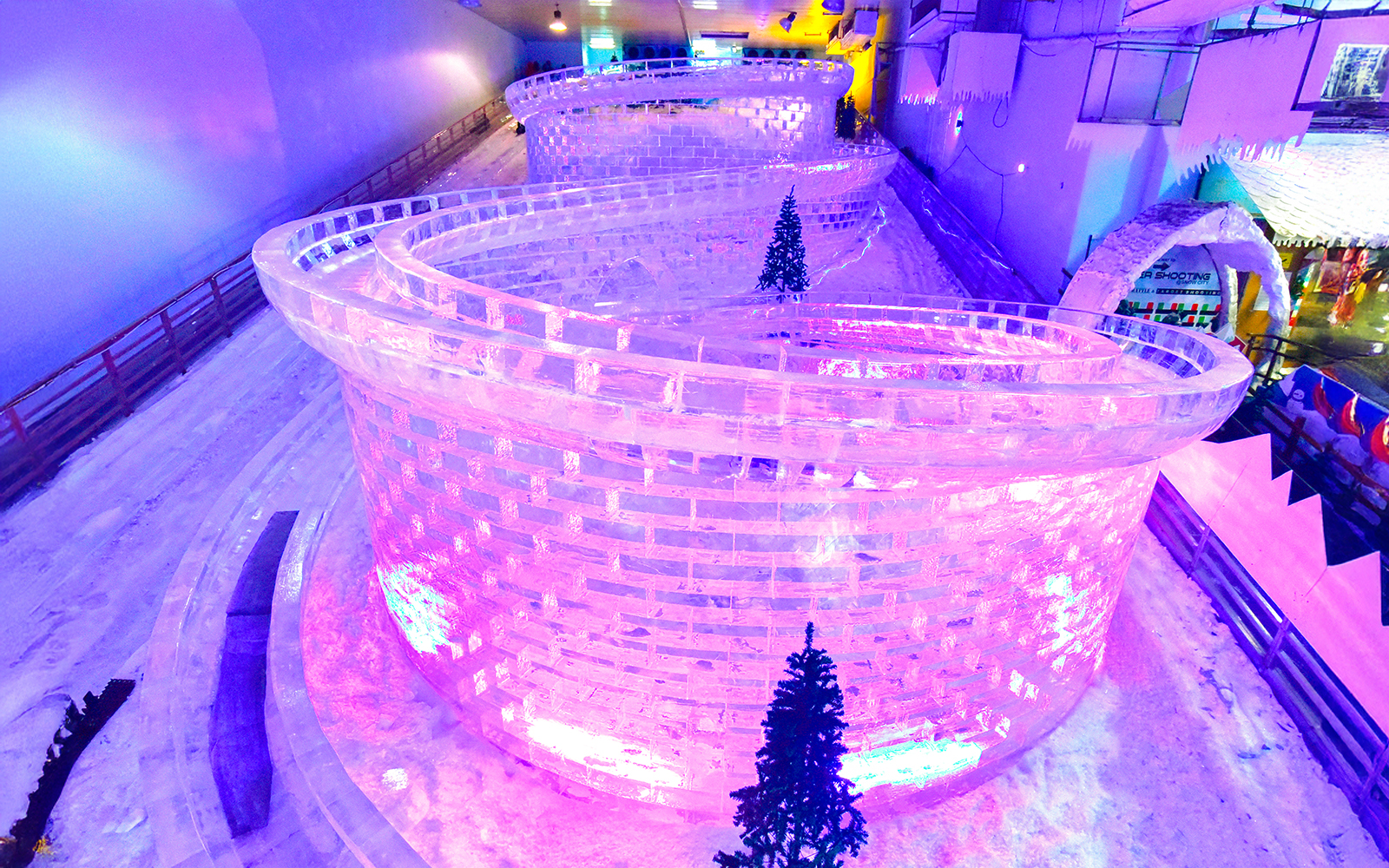 Glacier luge track with ice walls and snow at Singapore Snow City.